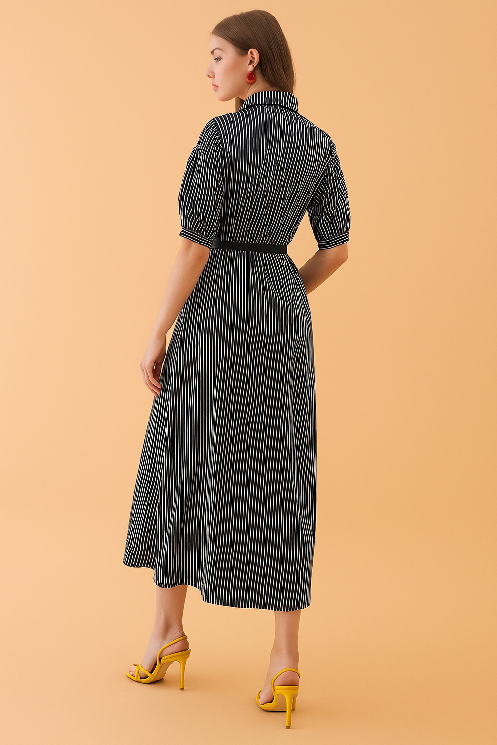 This chic striped dress for women features a crisp white shirt dress silhouette. Detailed with elegant black strips dress for women, it’s a versatile look for office or casual wear.