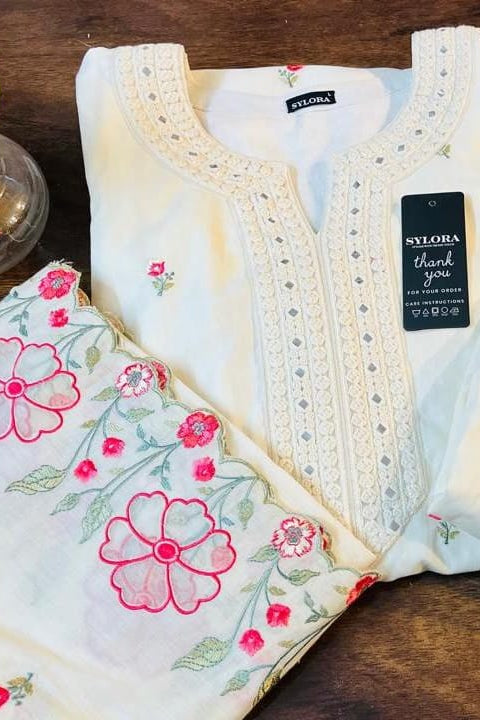 This stunning floral suit for women features intricate detailing and a graceful silhouette. A premium embroidered suit for women, this complete suit set for women is perfect for weddings and festive celebrations.