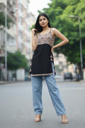 Floral sleeveless Nyra cut short kurti for women in soft cotton fabric. Stylish black cotton kurti, trending short kurta for women, perfect for daily and summer wear.