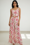 This vibrant dress for women features a stylish crop top paired with high-waisted flared palazzos. A modern floral dress for women perfect for summer outings and vacation style.