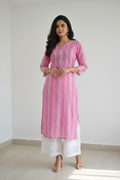 This lovely pink kurti features a delicate white geometric print and a sophisticated split-V neckline. A perfect kurti for women looking for comfortable and stylish daily wear, it includes charming tassel details on the sleeves.
