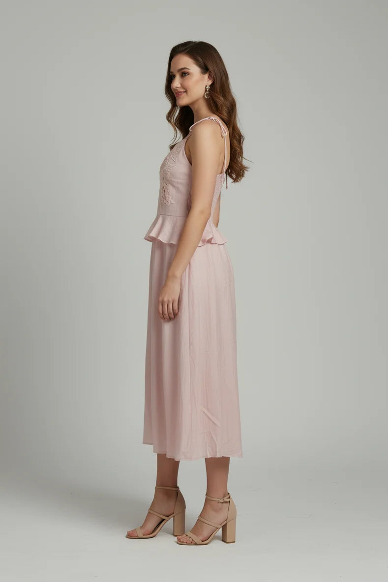 A versatile sleeveless design with embroidered detailing. Ideal midi length for vacations and special occasions.