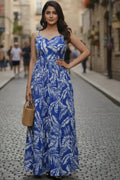 Stylish blue floral printed maxi dress for women featuring a long length, sleeveless design, and scoop neck. Perfect for casual wear, summer outings, and comfortable everyday fashion.