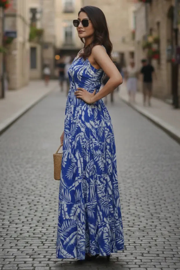 Stylish blue floral printed maxi dress for women featuring a long length, sleeveless design, and scoop neck. Perfect for casual wear, summer outings, and comfortable everyday fashion.