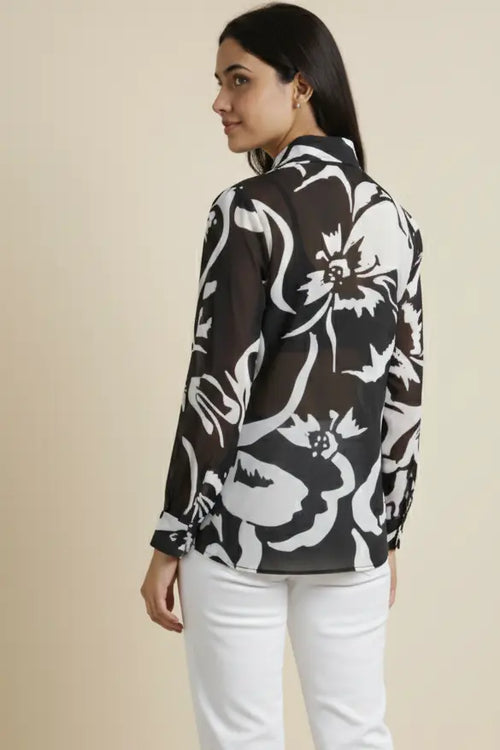 Elegant georgette shirt for women featuring a black and white print, full sleeves, and a classic collar. Perfect for casual outings, office wear, and stylish everyday looks.