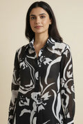 Elegant georgette shirt for women featuring a black and white print, full sleeves, and a classic collar. Perfect for casual outings, office wear, and stylish everyday looks.