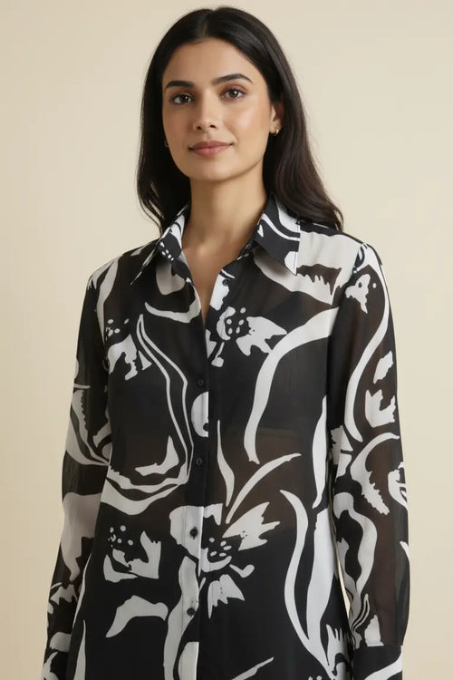 Elegant georgette shirt for women featuring a black and white print, full sleeves, and a classic collar. Perfect for casual outings, office wear, and stylish everyday looks.