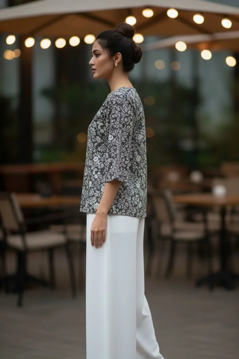 A stylish peplum top designed as a women floral top, perfect for pairing with blouses for women and ideal as trendy tank tops for women.- side