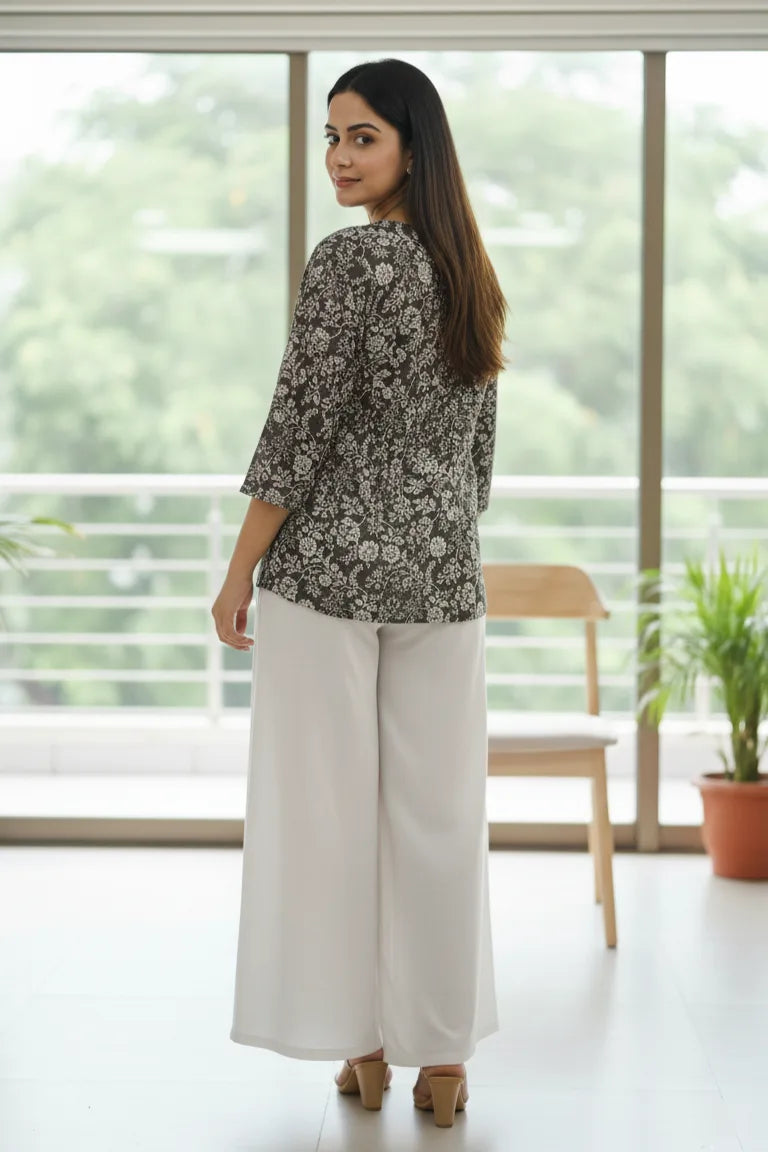 A stylish peplum top designed as a women floral top, perfect for pairing with blouses for women and ideal as trendy tank tops for women.- side